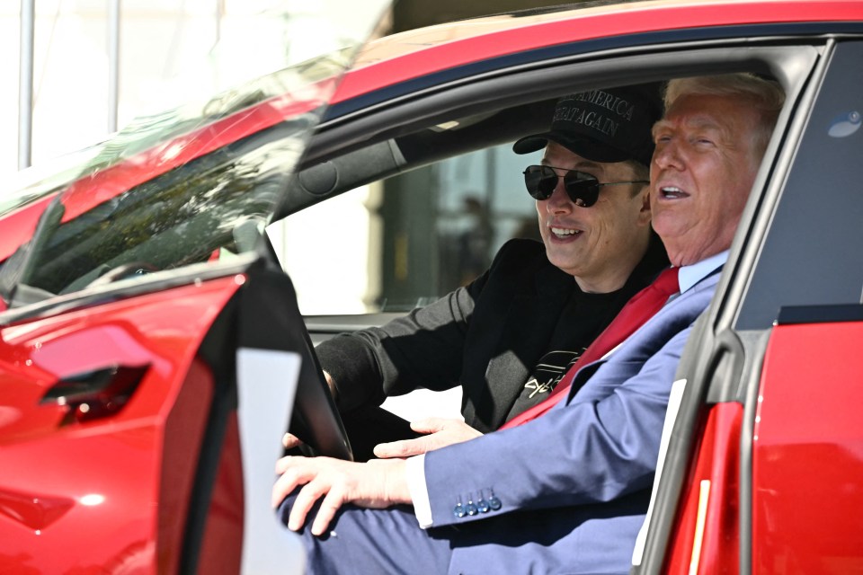 Elon Musk and Donald Trump in a red Tesla.