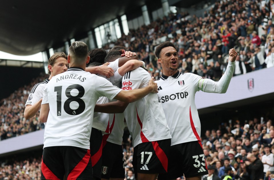 Fulham's Alex Iwobi celebrates scoring a goal with teammates.