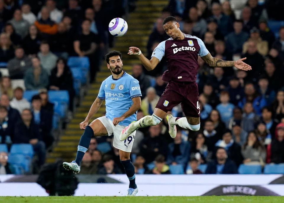 Ilkay Gundogan of Manchester City and Ezri Konsa of Aston Villa vying for the ball during a Premier League match.