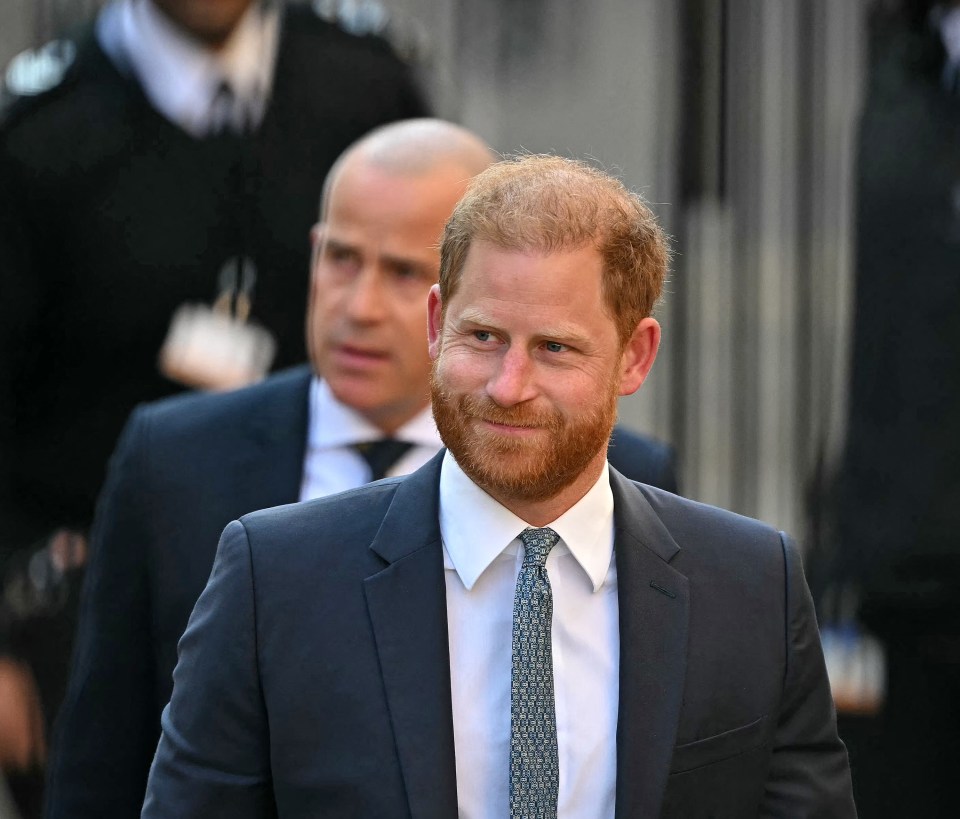 Prince Harry arriving at the High Court in London with security guards.