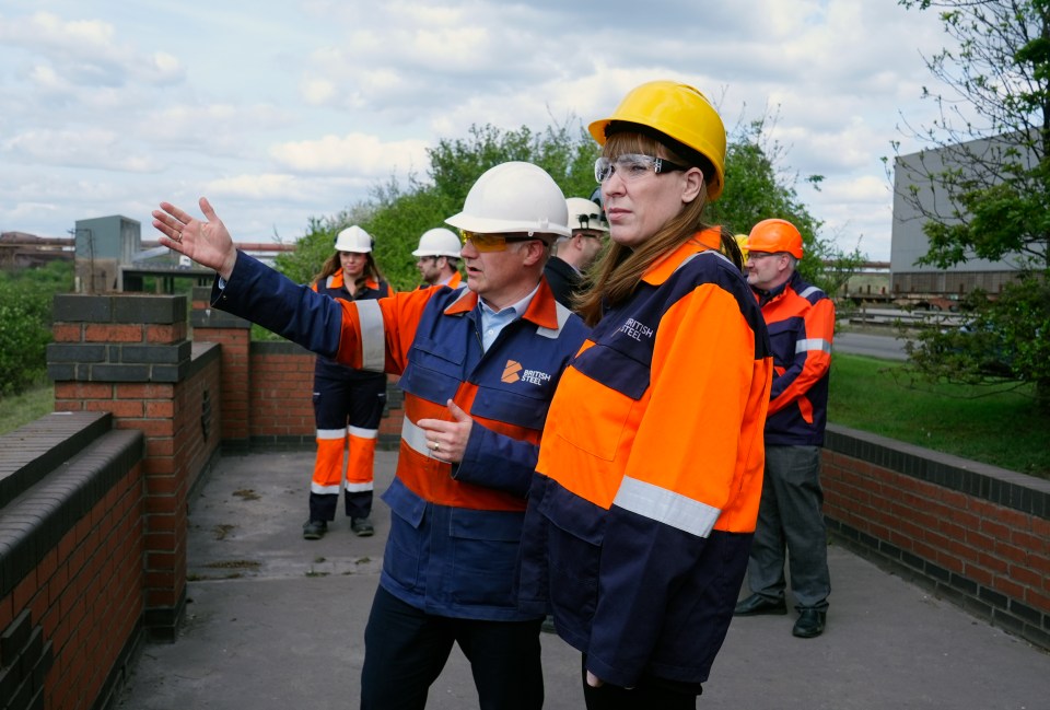 Government officials touring a British Steel plant.