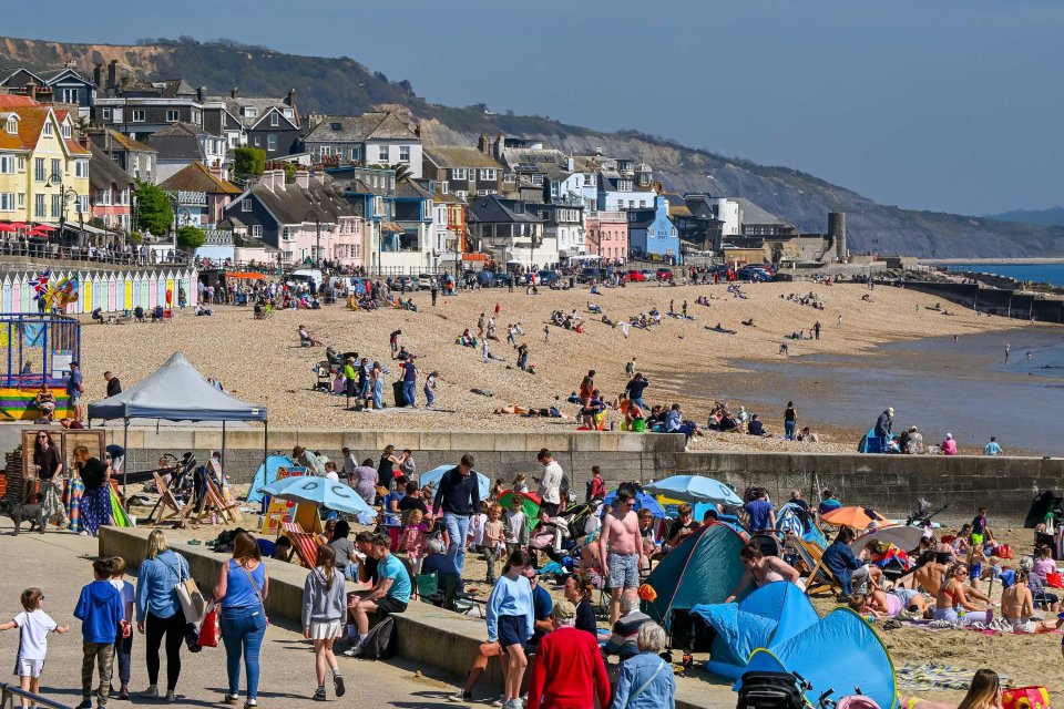 Crowded beach in Lyme Regis, Dorset, UK during Easter school holidays.
