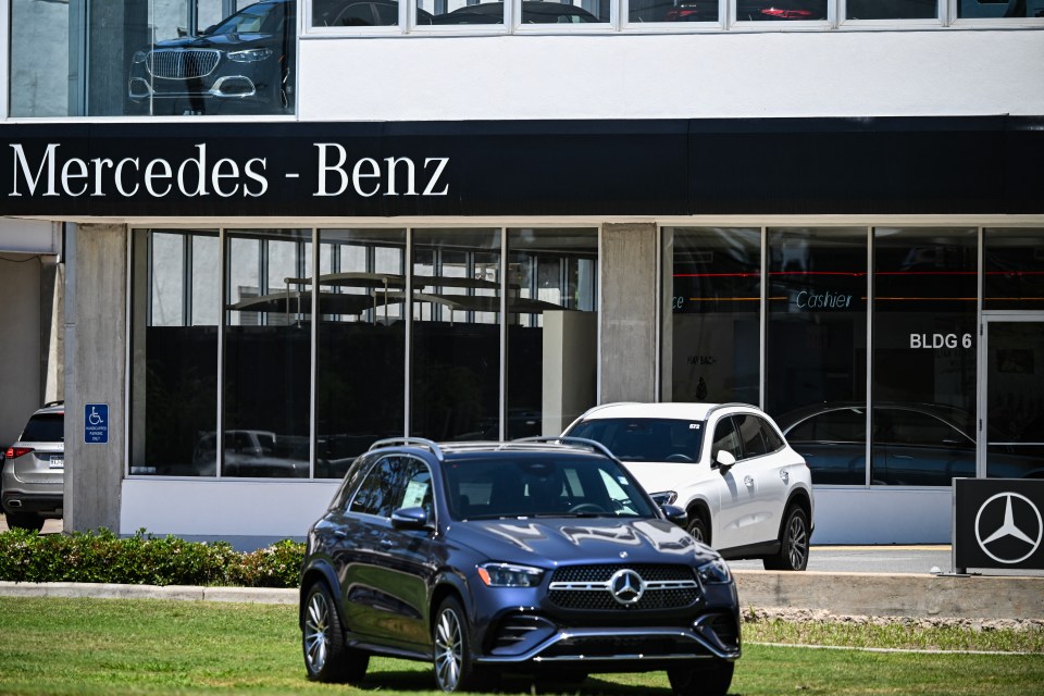 Mercedes-Benz dealership with cars on display.
