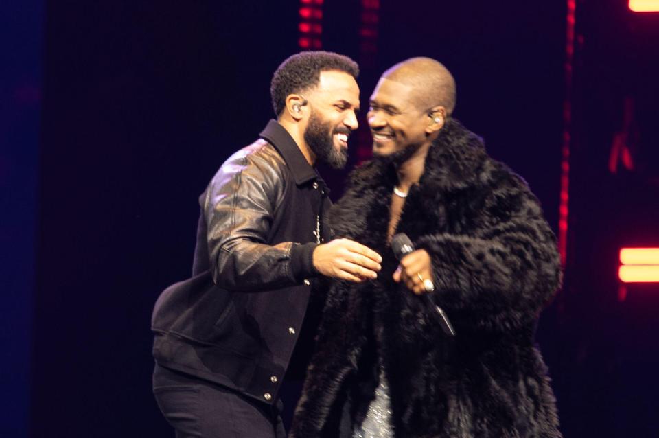 Usher and Craig David on stage together.
