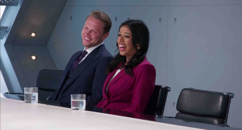 Dean Franklin and Anisa Khan, the final two candidates on The Apprentice, laughing at a table.