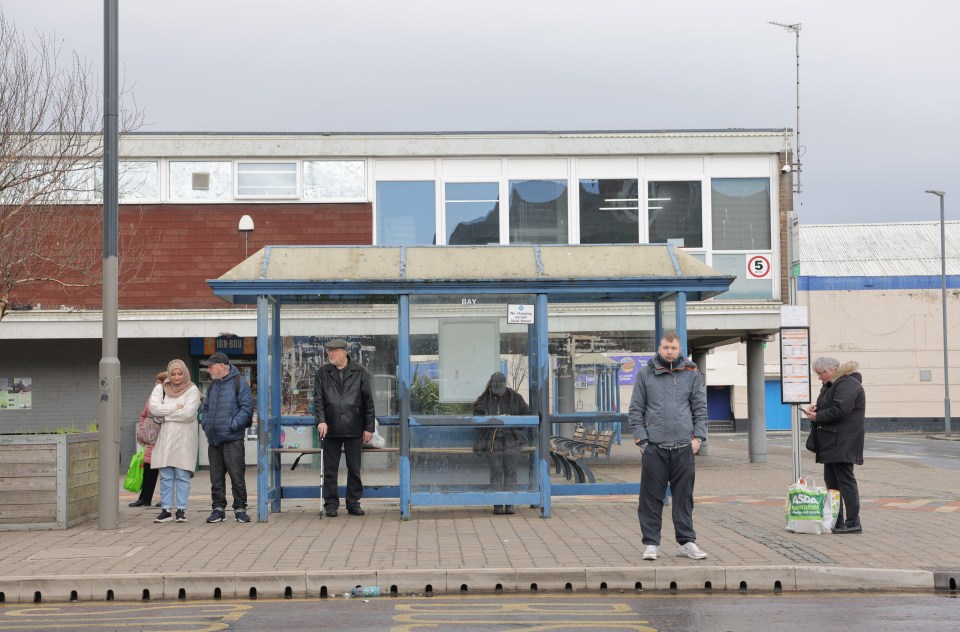 People waiting at a bus stop in Blyth, Northumberland.