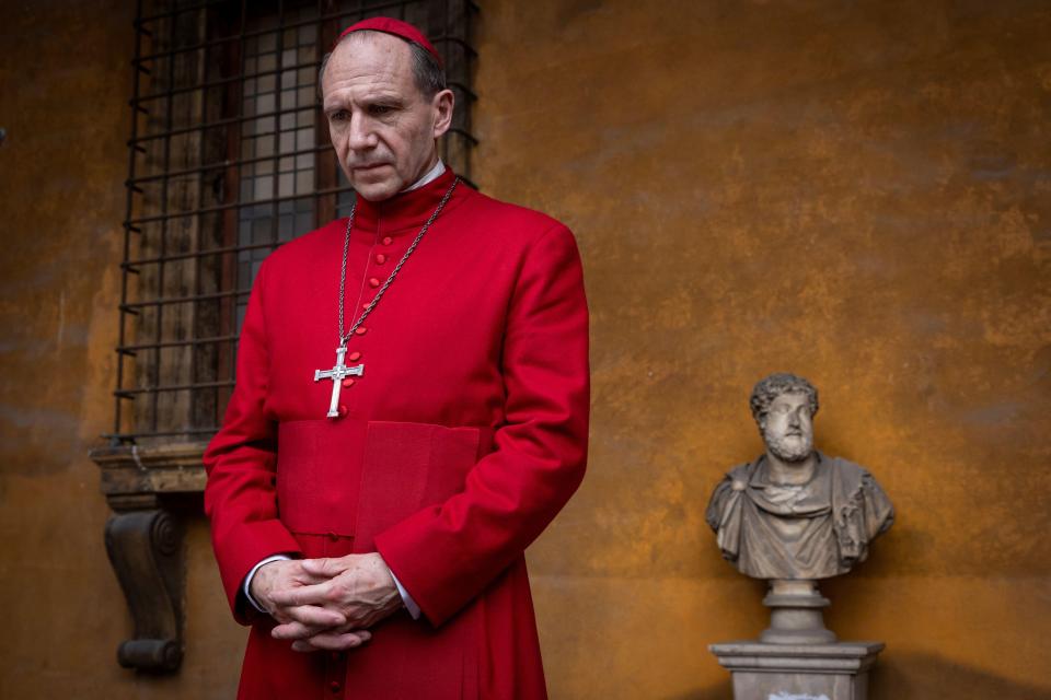 Ralph Fiennes in a red cardinal's robe.