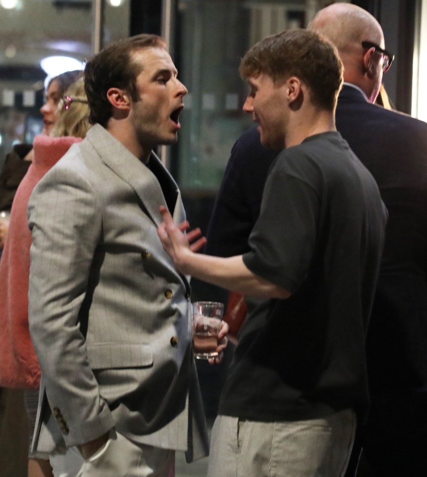 Two men arguing at a press night.