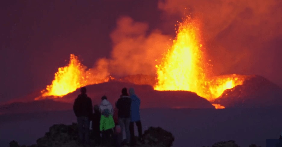 People watching a volcanic eruption.