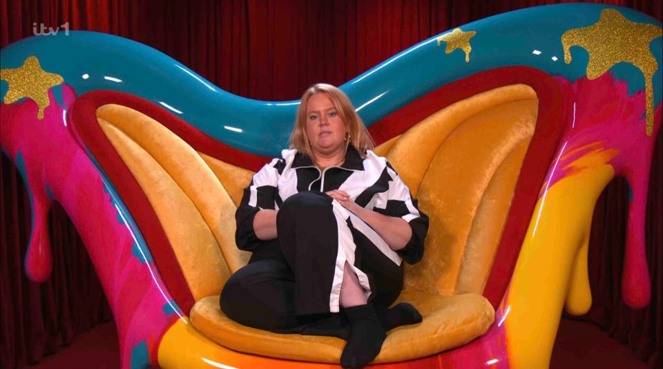 Woman sitting in a brightly colored chair.