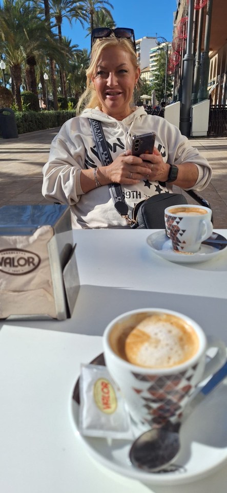 Woman having coffee in Alicante, Spain.
