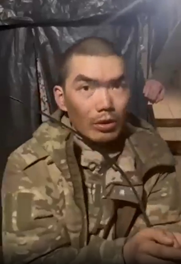 A soldier in camouflage uniform speaks.