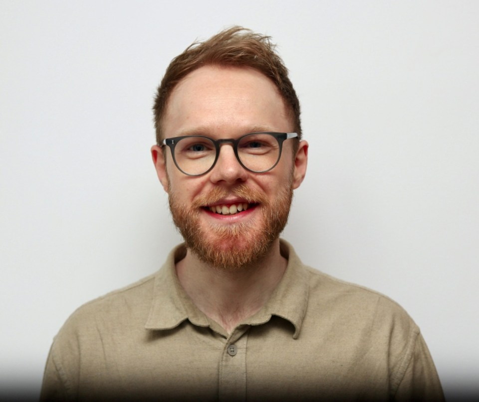 Portrait of a smiling man wearing glasses.
