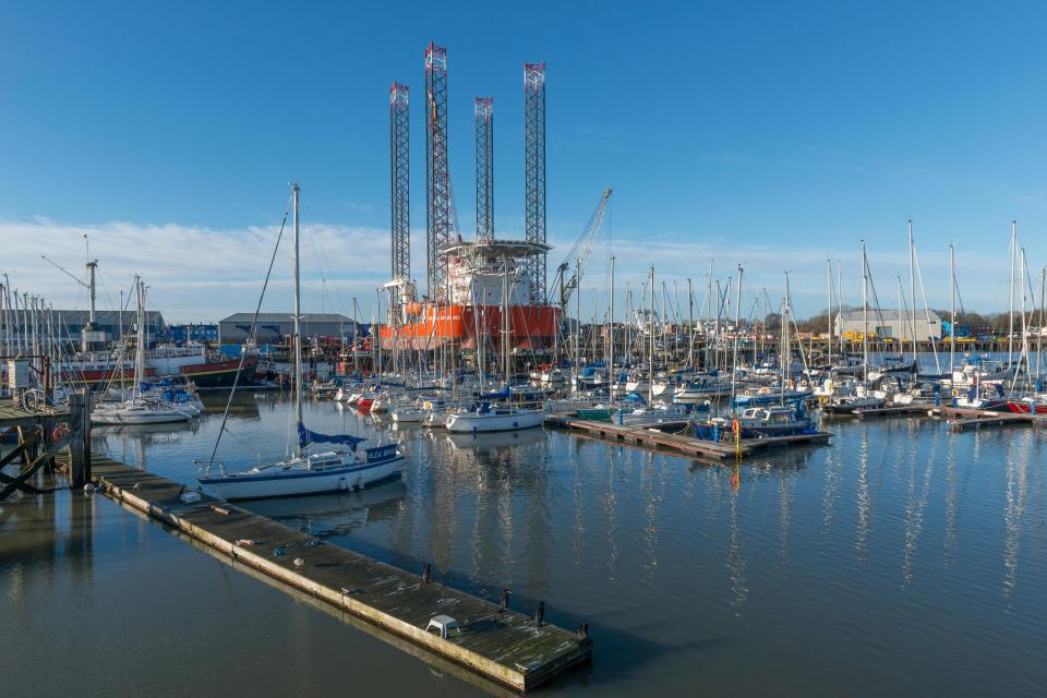 GMS Endeavor oil rig moored in South Harbour, Blyth, with many sailboats in the marina.