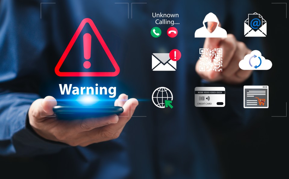Warning sign on smartphone screen indicating identity theft.