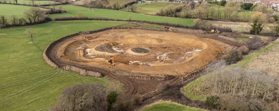 Aerial view of lake construction on a rural property.