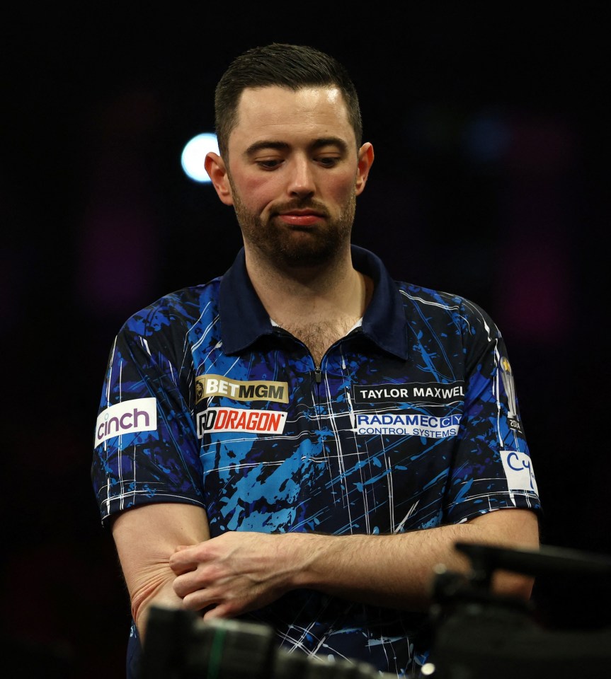 Luke Humphries reacting during a darts match.