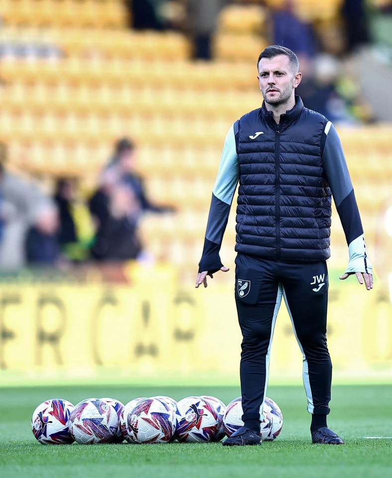 Jack Wilshere, Norwich City first-team coach, standing on the pitch.