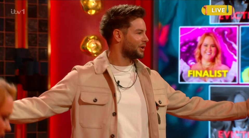 Man in tan jacket on a game show.