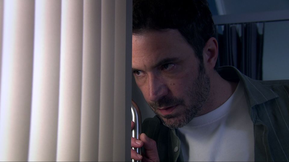 A man peeking around a corner.