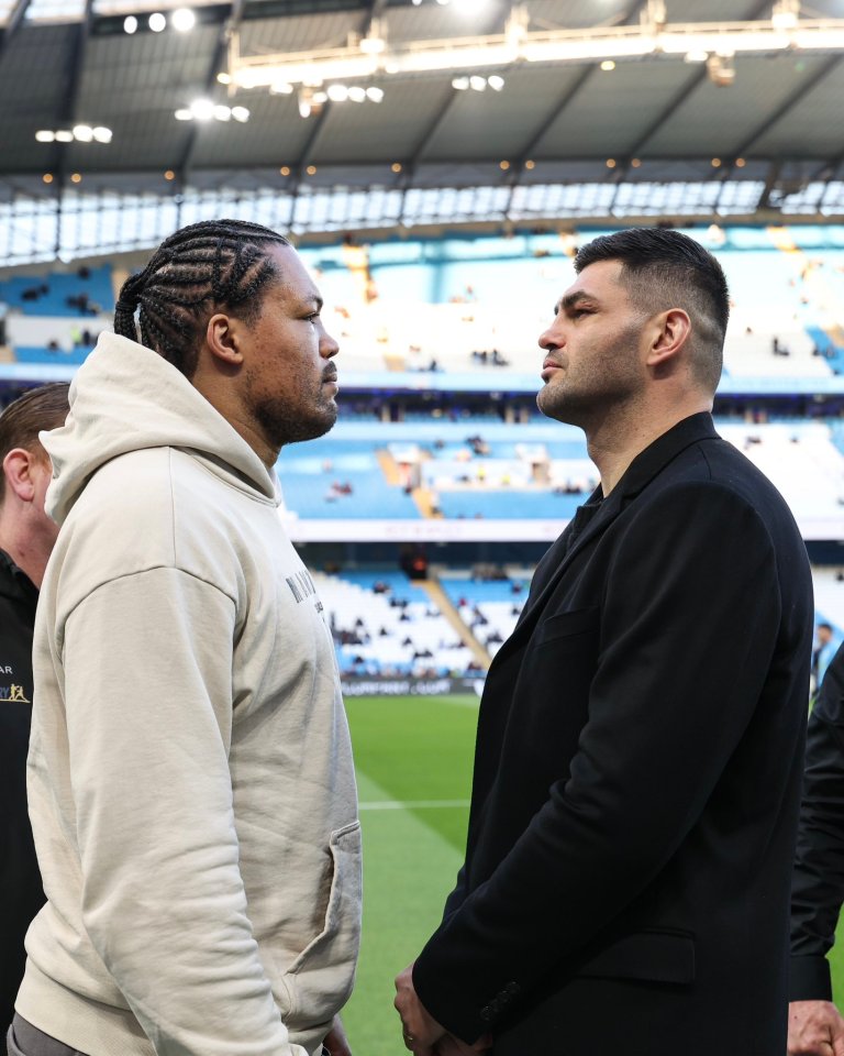 Two men facing each other in a stadium.