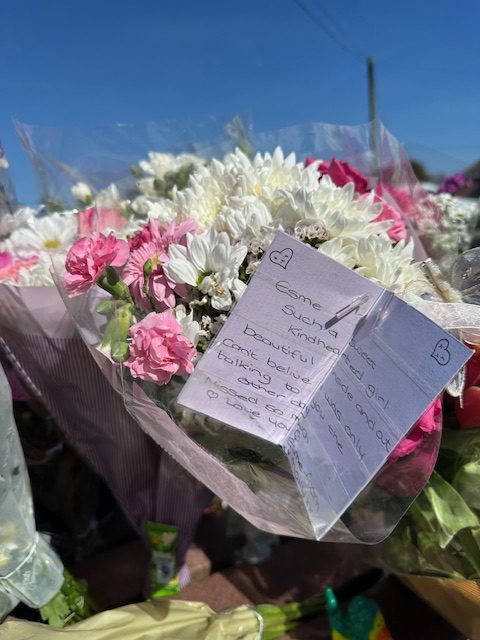 Bouquet of flowers with a handwritten note.