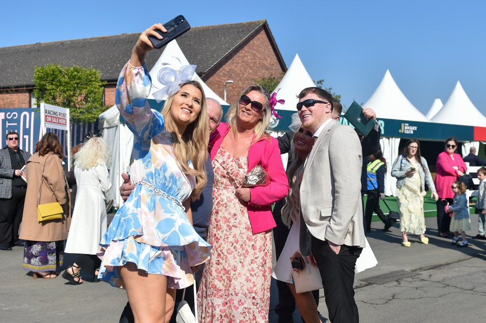 Aintree Grand National Festival attendees taking a selfie.