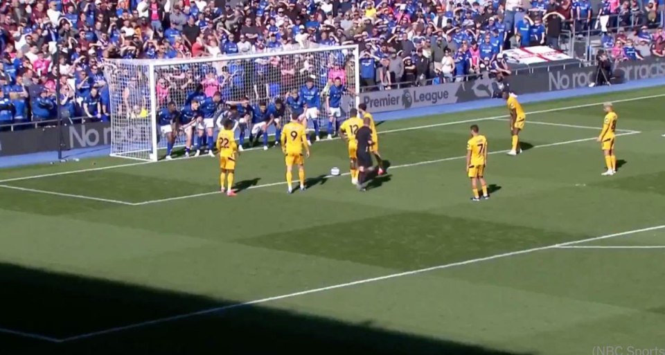 Soccer players preparing for a penalty kick.