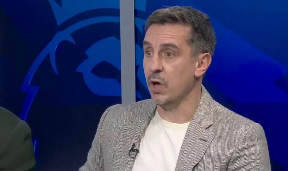 A man in a gray jacket speaking.