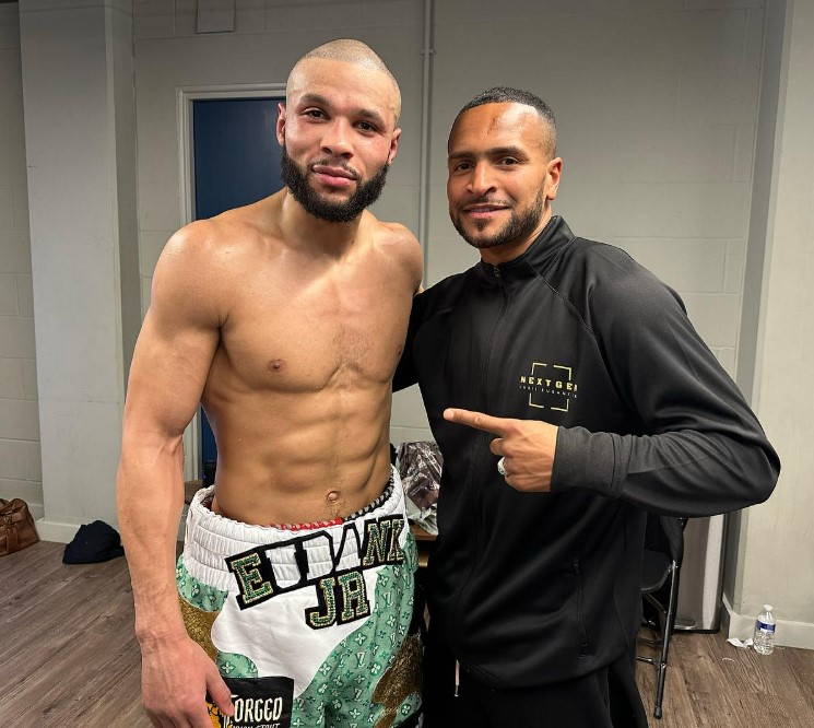 Two boxers posing together backstage.