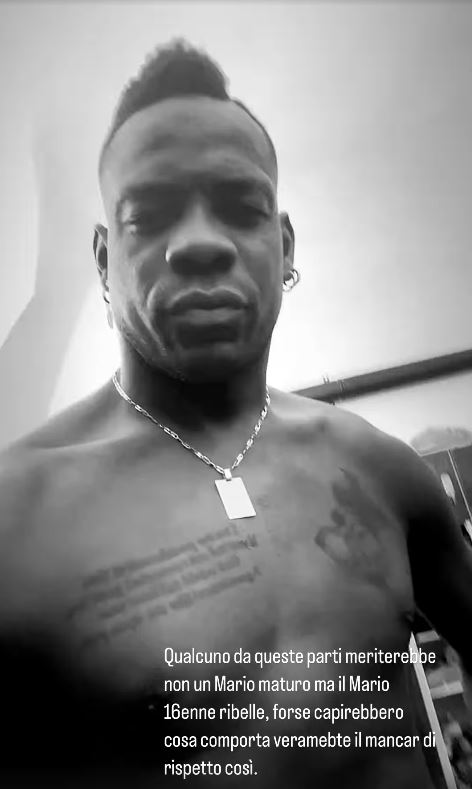 Black and white photo of a shirtless man with a necklace.