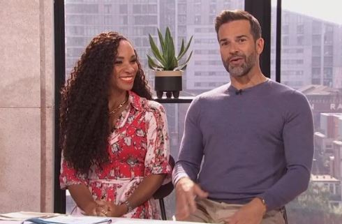 Two people sitting at a table and talking.