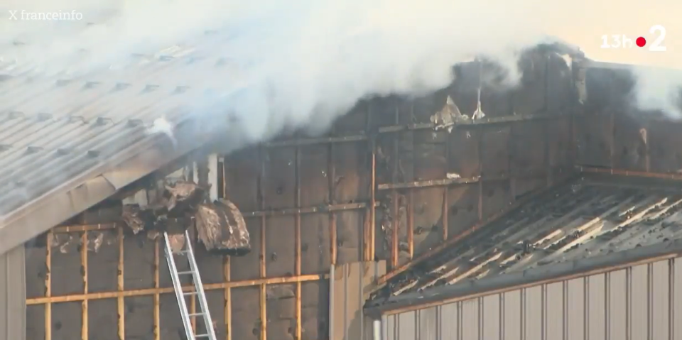 A fire damaging a building's exterior.
