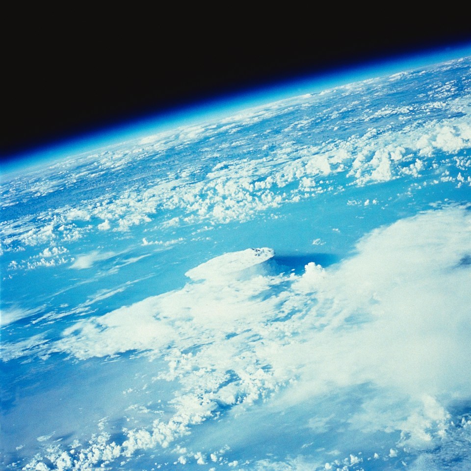 Satellite view of a mushroom cloud over Earth.