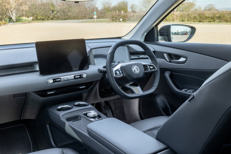Interior view of a car's dashboard and steering wheel.