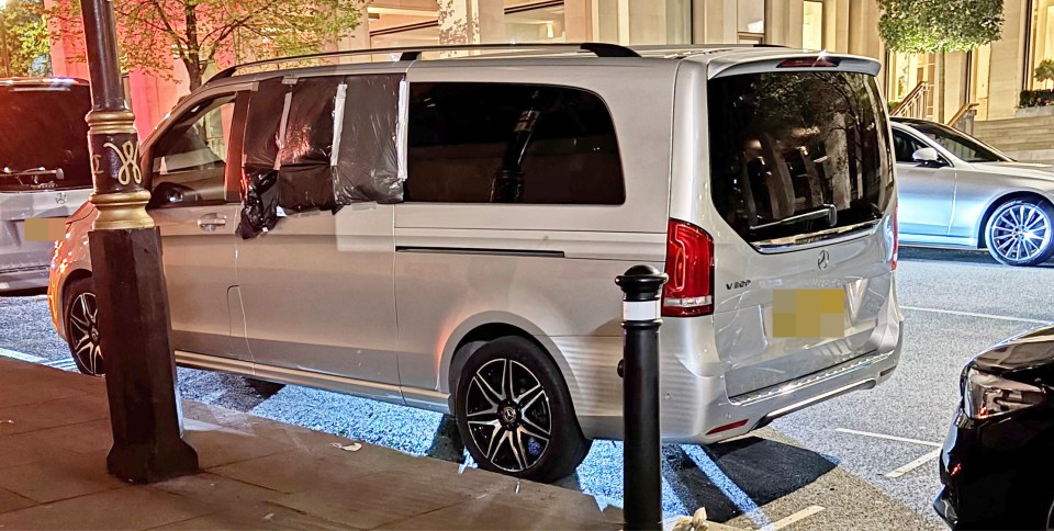 Silver Mercedes V-Class van parked at night with its windows covered.