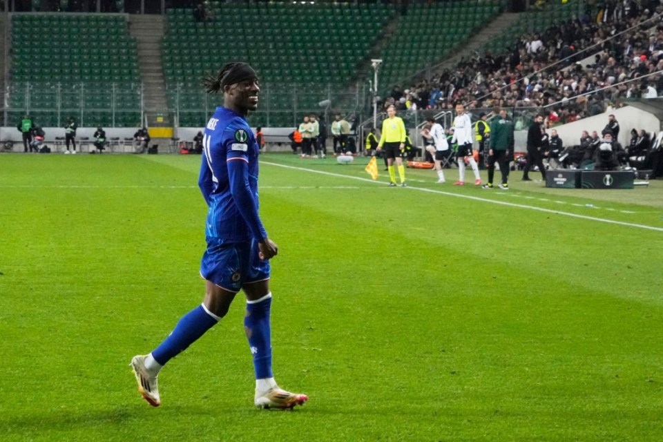 Chelsea's Noni Madueke, right, celebrates after scoring the third goal against Legia during the Europa Conference League first-leg quarterfinals soccer match between Legia Warszawa and Chelsea at the Marshall Jozef Pilsudski's Municipal stadium in Warsaw, Poland, Thursday, April 10, 2025. (AP Photo/Czarek Sokolowski)