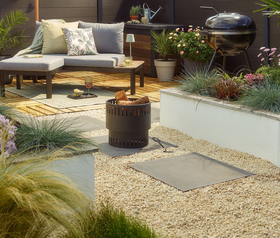 Outdoor patio with seating area, fire pit, and grill.