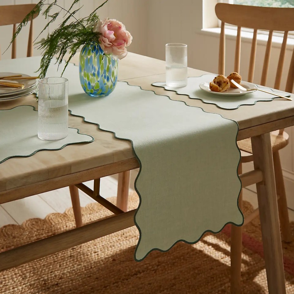 Scalloped-edge table runner on a dining table.