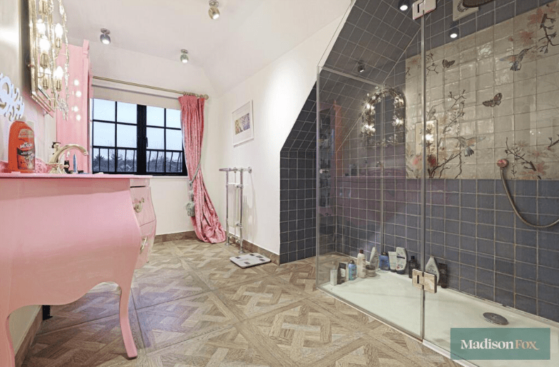 Pink bathroom with a large walk-in shower.