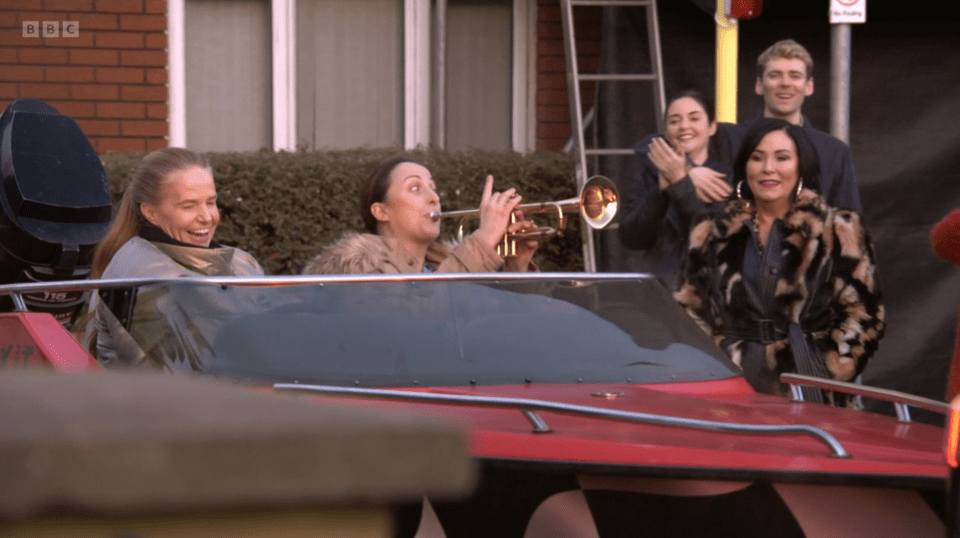 Screenshot of people in a speedboat, one playing a trumpet.