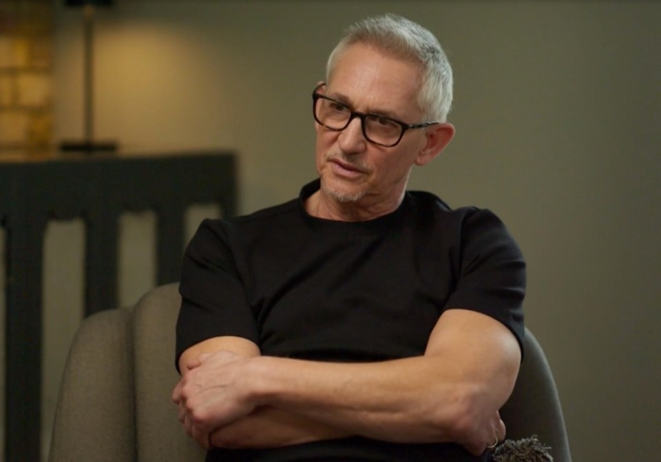 Screenshot of a man sitting in a chair.