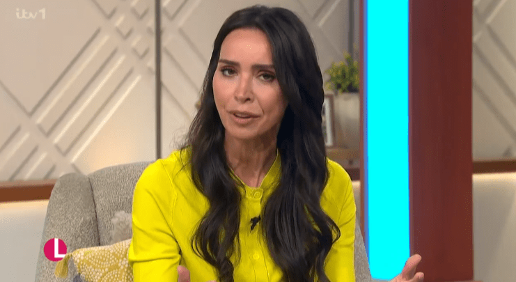 Screenshot of a woman in a yellow shirt speaking.