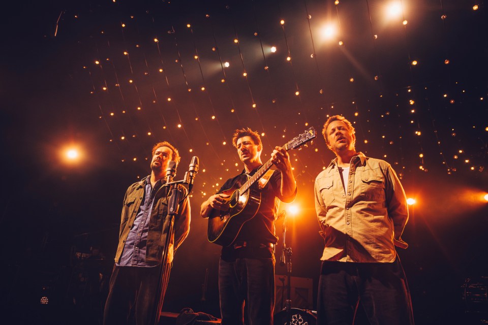 Mumford & Sons performing on stage.