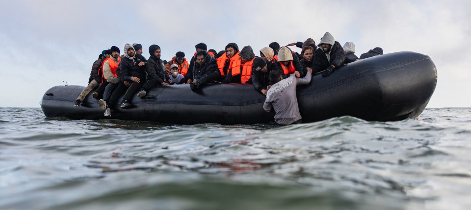 Migrants in a small boat attempting to cross the English Channel.