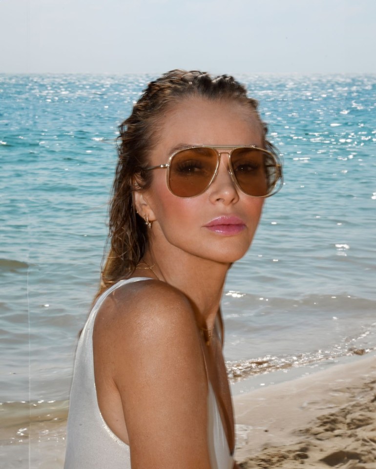 Woman in sunglasses at the beach.