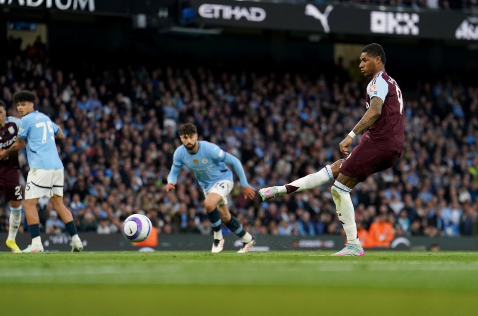 Marcus Rashford scoring a goal during a soccer match.