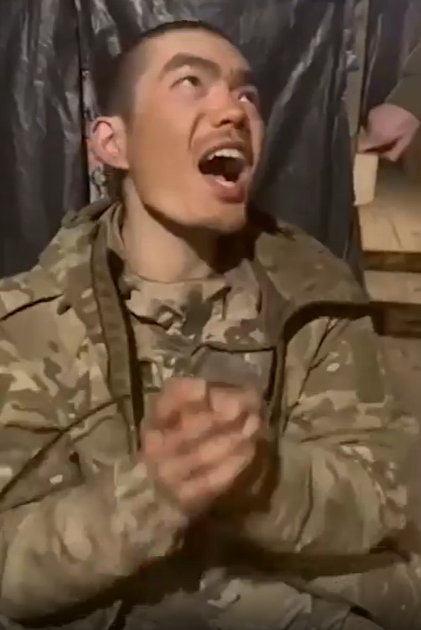 Soldier in camouflage uniform clapping and shouting.