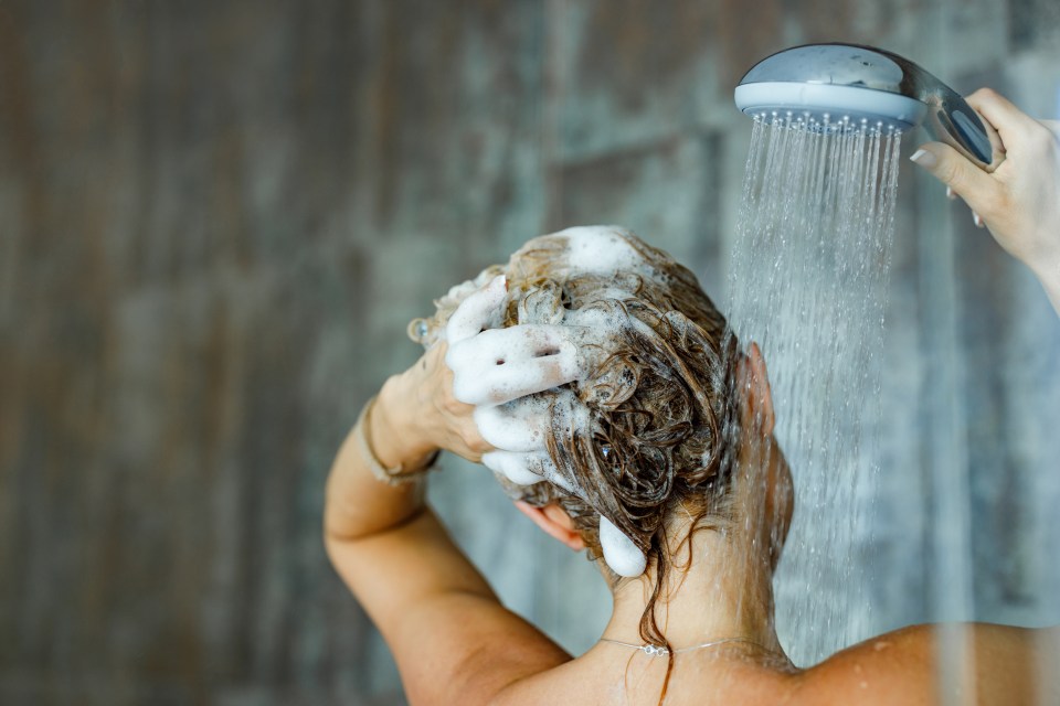Woman washing her hair in the shower.