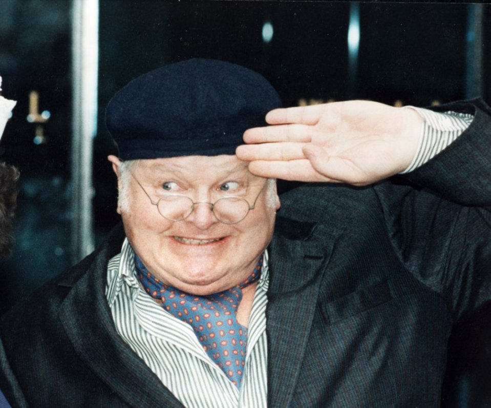 Benny Hill as Fred Scuttle saluting.